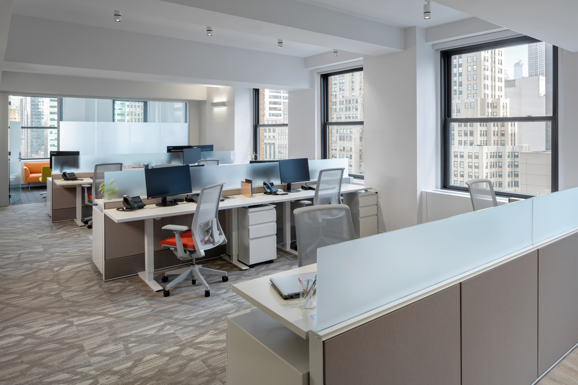 The open space encourages communication. Sit-stand desks & ergonomic chairs help people's health.